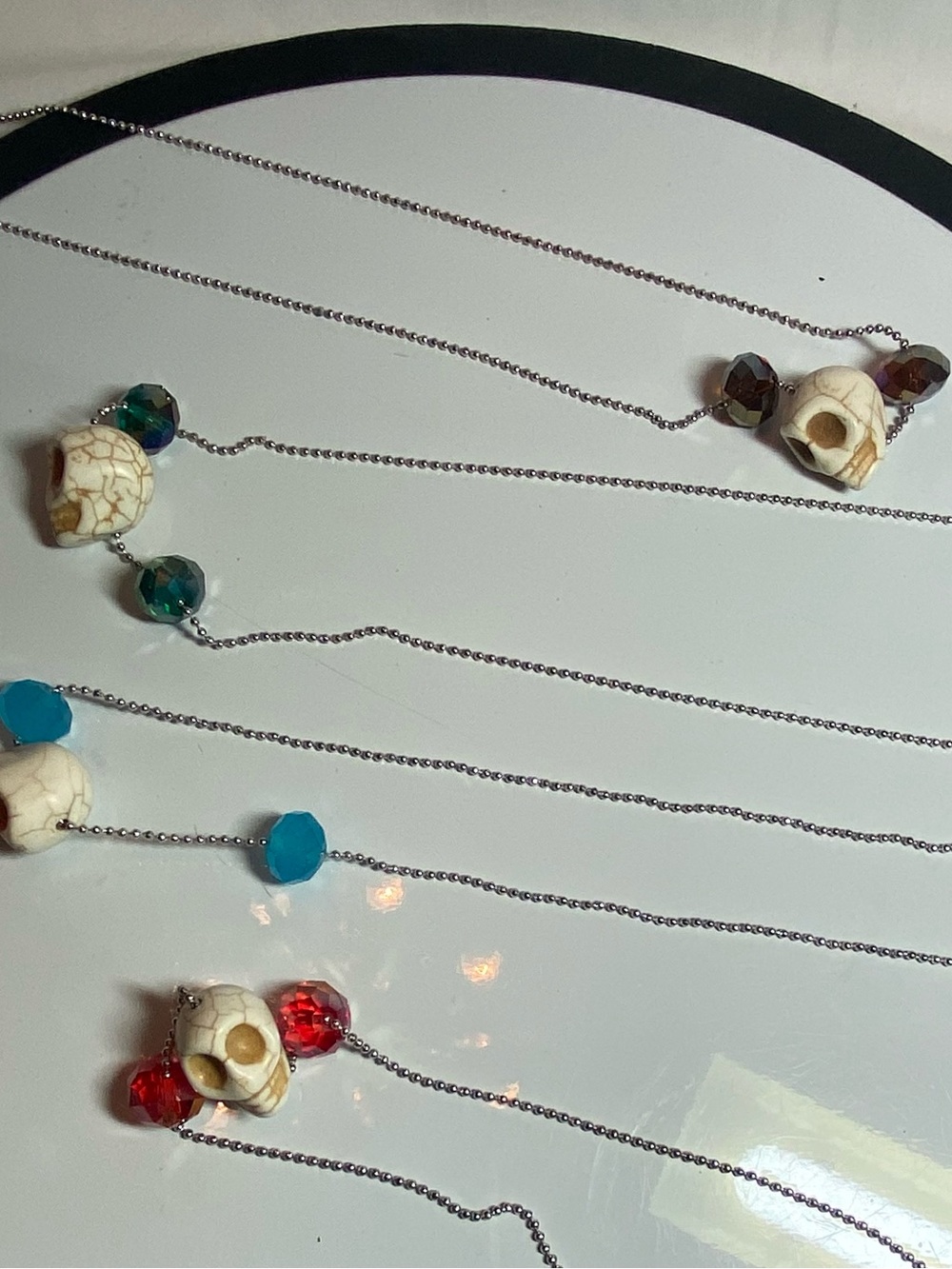 Set of 4 necklaces. Featuring skull beads and cut glass beads. Drop 13.5”